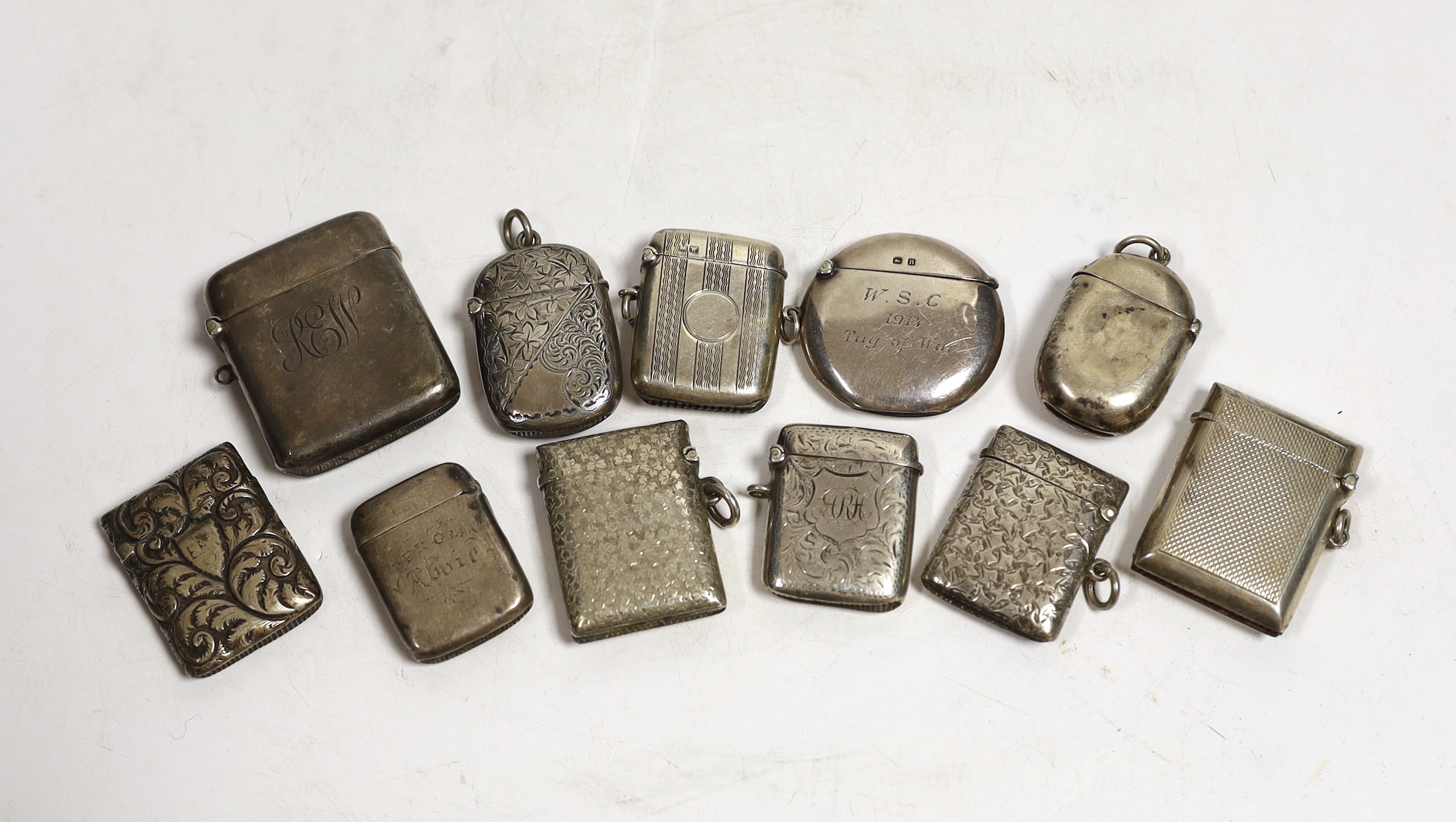 Nine assorted mainly early 20th century silver vesta cases and one similar white metal vesta case, largest 52mm.